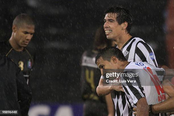 Victor Caceres and Sergio Aquino of Libertad celebrate victory over Once Caldas during a match as part of the Libertadores Cup 2010 at Defensores del...
