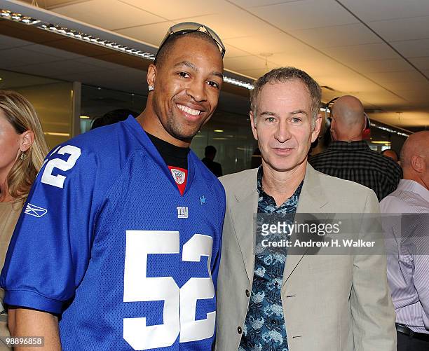 Michael Boley and John McEnroe attend the 8th Annual Commissions for Charity Day at BTIG on May 6, 2010 in New York City.