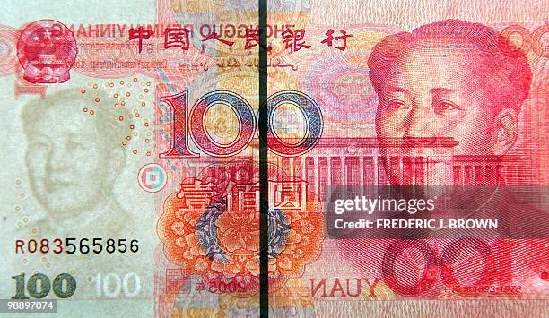 Closeup image shows both sides of a Chinese currency 100 Yuan note in Beijing on May 7 with former Communist Party leader Mao Zedong on one side and...