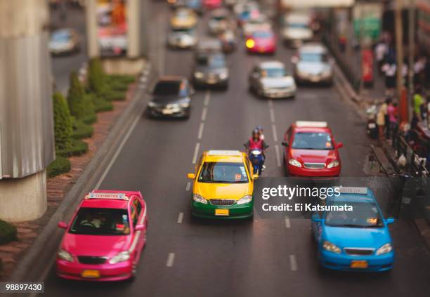 colorful bangkok taxicab traffic - rush hour tilt shift stock pictures, royalty-free photos & images
