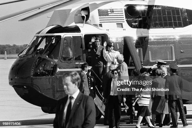 Crown Prince Akihito and Crown Princess Michiko wave to well-wishers as they transfer to a helicopter at the Joint Base Andrews on October 5, 1987 in...