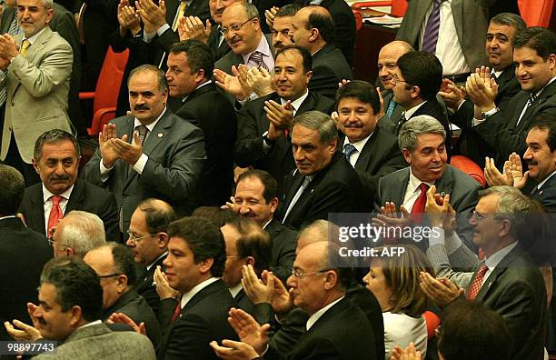 Lawmakers of Turkey's ruling Justice and Development Party celebrate after a package of amendments to the 1982 constitution was approved at the...