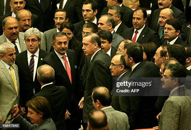 Lawmakers of Turkey's ruling Justice and Development Party surround Prime Minister Recep Tayyip Erdogan as they celebrate after a package of...