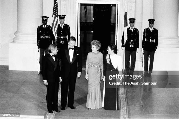 Crown Prince Akihito and Crown Princess Michiko are welcomed by U.S. President Ronald Reagan and his wife Nancy prior to their dinner at the White...