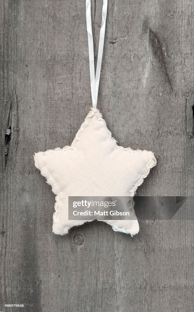 Generic machine made Christmas star ornament on rustic style bac