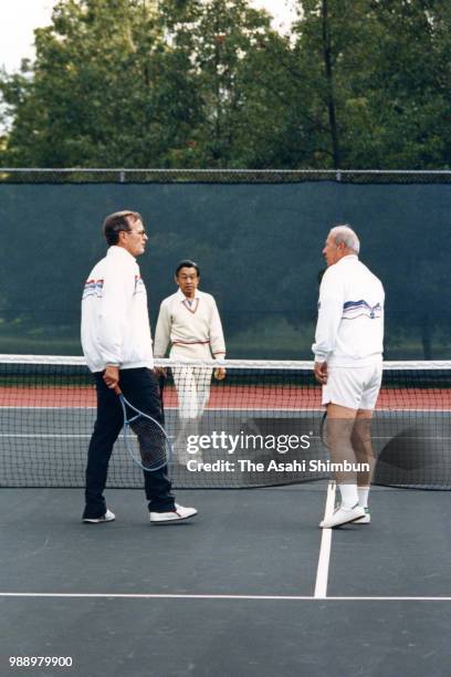 Crown Prince Akihito plays tennis with U.S. Vice President George Bush and Secretary of State George Shultz at the official residence of the vice...