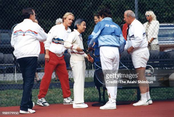 Crown Prince Akihito plays tennis with U.S. Vice President George Bush and Secretary of State George Shultz at the official residence of the vice...