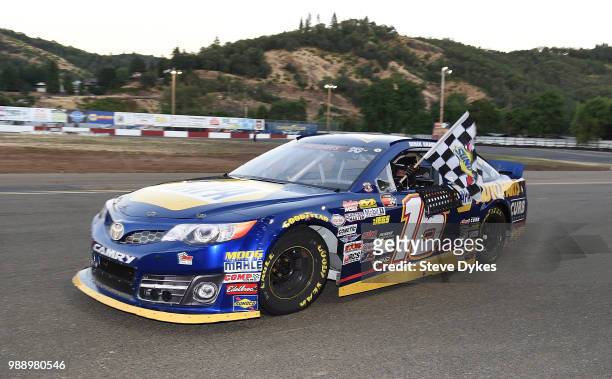 Derek Kraus ctakes a victory lap after winning the Clint Newell Toyota 150 presented by NAPA Auto Parts for the NASCAR K&N West Series at the Douglas...