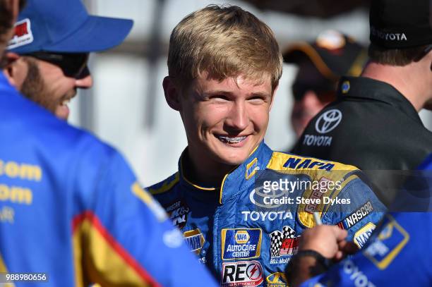 Derek Kraus smiles as he speaks with his crew in the pits before the Clint Newell Toyota 150 presented by NAPA Auto Parts for the NASCAR K&N West...