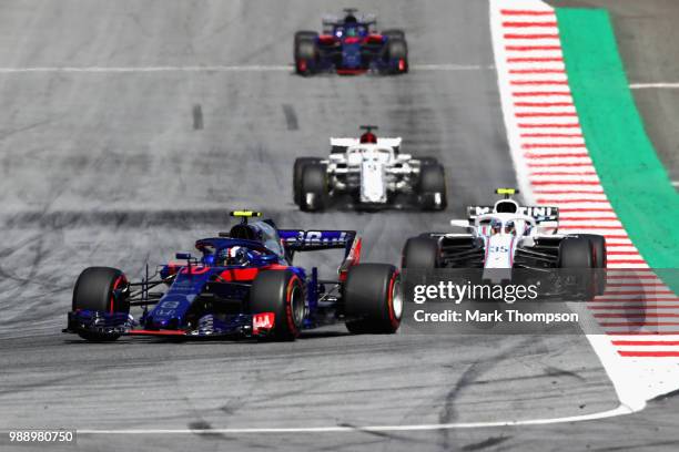 Pierre Gasly of France and Scuderia Toro Rosso driving the Scuderia Toro Rosso STR13 Honda leads Sergey Sirotkin of Russia driving the Williams...