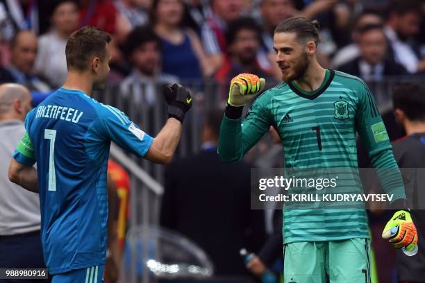 Russia's goalkeeper Igor Akinfeev chats with Spain's goalkeeper David De Gea during the Russia 2018 World Cup round of 16 football match between...