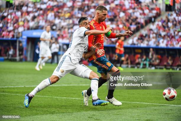 Aleksander Samedov of Russia and Sergio Ramos of Spain during the FIFA World Cup Round of 26 match between Spain and Russia at Luzhniki Stadium on...