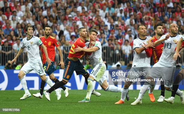 Sergio Ramos of Spain clashes with Ilya Kutepov of Russia during the 2018 FIFA World Cup Russia Round of 16 match between Spain and Russia at...