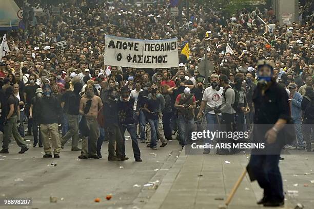 Protestors carry a banner reading ' Tonight fasism dies ' during a violent demonstration in the center of Athens on May 5, 2010. A nationwide general...