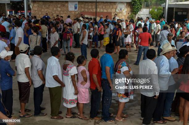 Mexican Maya ethnic group natives queue to vote during the general elections in Hunuku, Yucatan State on July 1, 2018. Mexicans go to the polls...