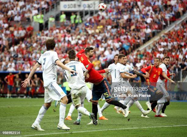 Gerard Pique, Sergio Ramos and Rodrigo of Spain battle with the Russia players in the box during the 2018 FIFA World Cup Russia Round of 16 match...