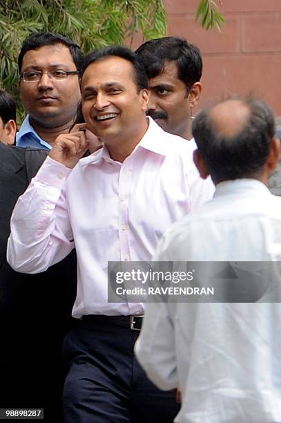 Reliance Dhirubhai Group Chairman Anil Ambani smiles as he leaves the Supreme Court in New Delhi on May 7 after hearing judgements in a legal dispute...