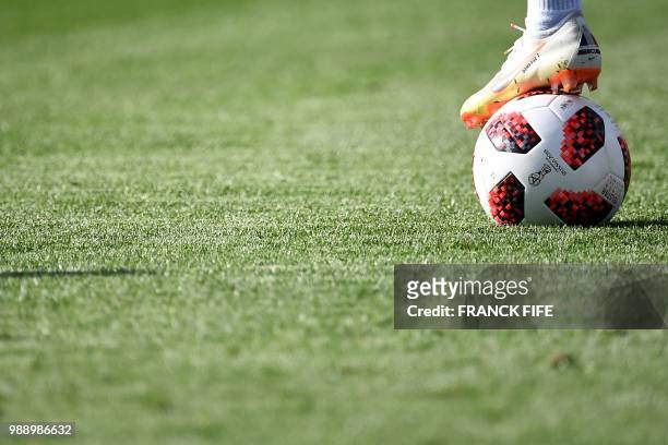 France's forward Ousmane Dembele rests his foot on a ball during a training session at the Glebovets stadium in Istra, some 70 km west of Moscow, on...