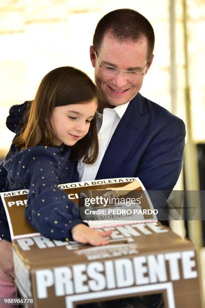 Mexico's presidential candidate Ricardo Anaya for the "Mexico al Frente" coalition party, casts his vote with his daughter Carmen, during general...