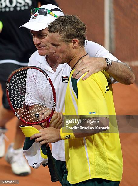 Lleyton Hewitt of Australia is congratulated by his team captain John Fitzgerald after his match against Tatsuma Ito of Japan during the match...