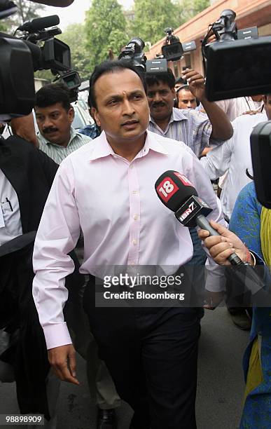 Anil Ambani, chairman of Reliance Power Ltd., walks through a group of reporters outside of the India Supreme Court in New Delhi, India, on Friday,...