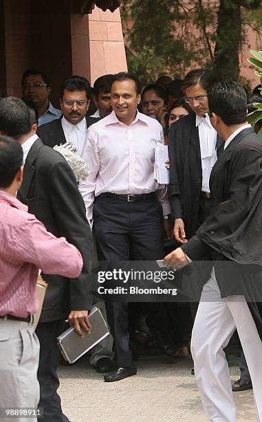 Anil Ambani, chairman of Reliance Power Ltd., walks through a group of reporters outside of the India Supreme Court in New Delhi, India, on Friday,...