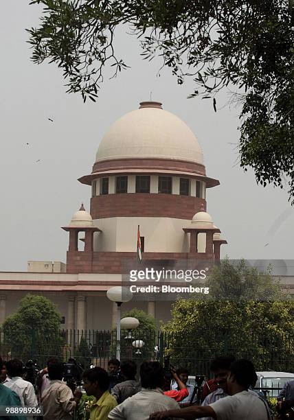 Members of the media gather outside of the India Supreme Court in New Delhi, India, on Friday, May 7, 2010. India's top court ruled in favor of...