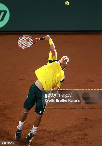 Lleyton Hewitt of Australia serves during his match against Tatsuma Ito of Japan during the match between Australia and Japan on day one of the Davis...