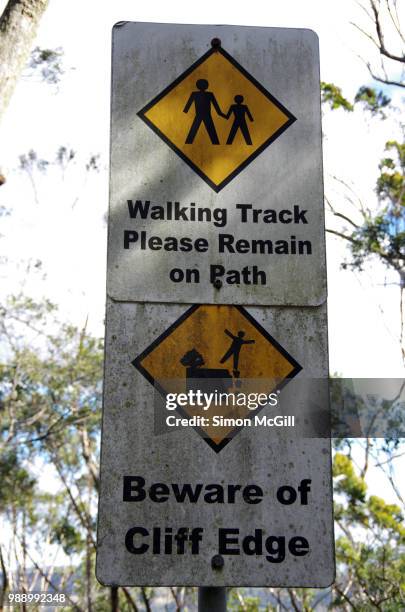 'walking track: please remain on path' and 'beware of cliff edge' signs - bowral stock pictures, royalty-free photos & images