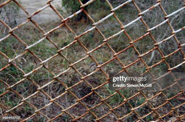 rusting chainlink wire fence around a paddock - bowral new south wales stock pictures, royalty-free photos & images