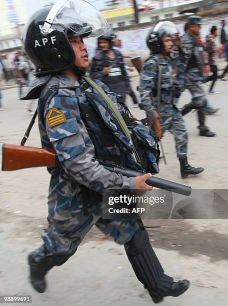 Nepalese police run to control crowds of protesters following clashes between Maoist supporters and police in Kathmandu on May 7, 2010. The United...