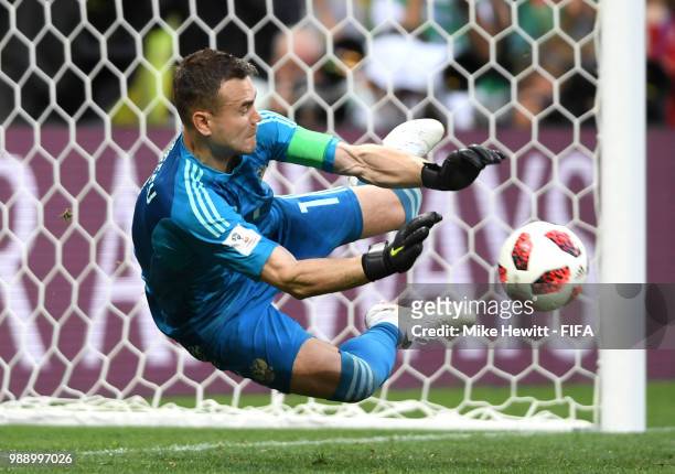 Igor Akinfeev of Russia saves the third penalty from Koke of Spain in the penalty shoot out during the 2018 FIFA World Cup Russia Round of 16 match...