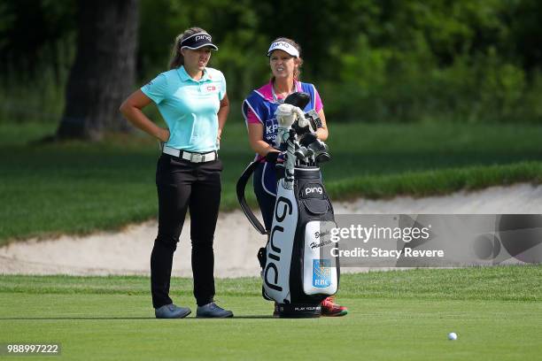 Brooke Henderson of Canada waits with her caddie on the first hole during the final round of the KPMG Women's PGA Championship at Kemper Lakes Golf...