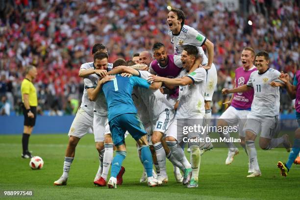 Akinfeev of Russia is celebrated by team mates following the penalty shoot out during the 2018 FIFA World Cup Russia Round of 16 match between Spain...