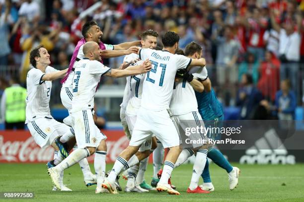 Akinfeev of Russia is celebrated by team mates following the penalty shoot out during the 2018 FIFA World Cup Russia Round of 16 match between Spain...