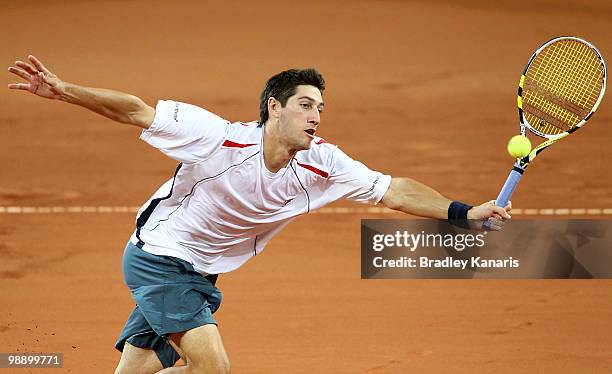 Carsten Ball of Australia plays a forehand volley during his match against Yuichi Sugita of Japan during the match between Australia and Japan on day...