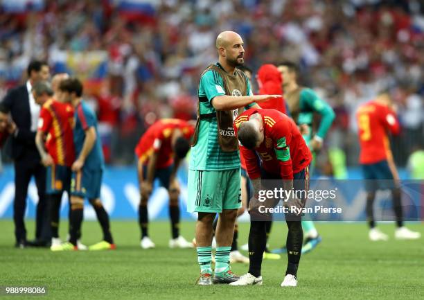 Pepe Reina consoles team mate Sergio Ramos of Spain following the 2018 FIFA World Cup Russia Round of 16 match between Spain and Russia at Luzhniki...