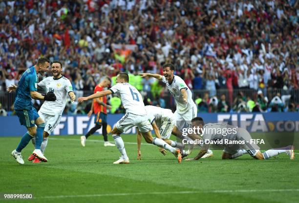 Akinfeev of Russia is celebrated by team mates following the penalty shoot out during the 2018 FIFA World Cup Russia Round of 16 match between Spain...