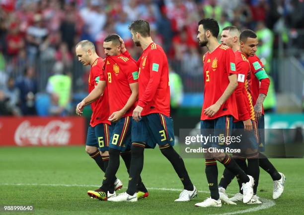 Andres Iniesta, Koke, and Gerard Pique of Spain look dejected following their sides defeat in the 2018 FIFA World Cup Russia Round of 16 match...