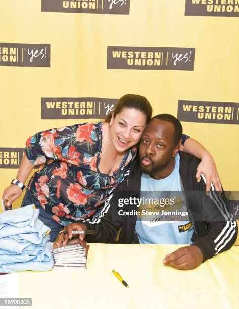 Wyclef Jean poses with a fan at the Western Union "Returns The Love" To Moms at Money Mart on May 6, 2010 in San Francisco, California.