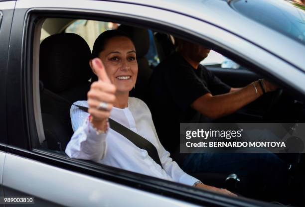 The candidate for governor for Mexico City Claudia Sheinbaum of the "Juntos haremos historia" coalition party, gives her thumb up after voting during...