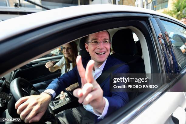 Mexico's presidential candidate Ricardo Anaya for the "Mexico al Frente" coalition party, flashes the victory sign after voting during general...