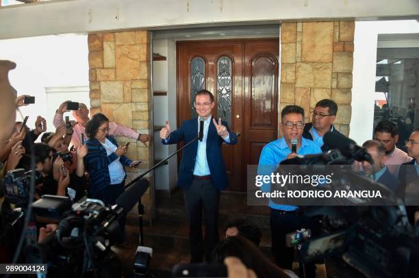 Mexico's presidential candidate Ricardo Anaya for the "Mexico al Frente" coalition party, shows his inked finger and flashes the victory sign after...