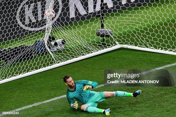 Spain's goalkeeper David De Gea takes a goal kicked by Russia's defender Sergey Ignashevich in a penalty shootout during the Russia 2018 World Cup...