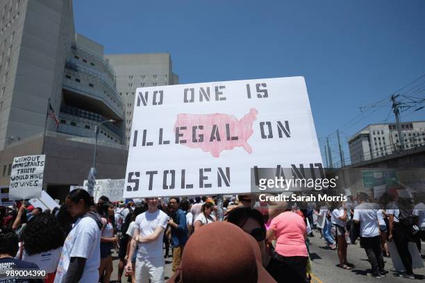 Demonstrator participates in the Families Belong Together - Freedom For Immigrants March at Los Angeles City Hall on June 30, 2018 in Los Angeles,...