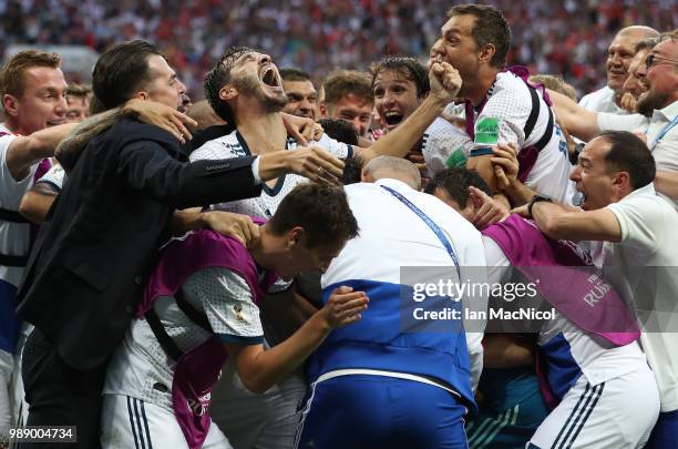 The Russia team celebrate with Aleksandr Erokhin of Russia during the 2018 FIFA World Cup Russia Round of 16 match between Spain and Russia at...