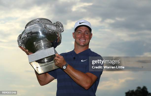 Alex Noren of Sweden celebrates with the trophy after winning the HNA Open de France at Le Golf National on July 1, 2018 in Paris, France.