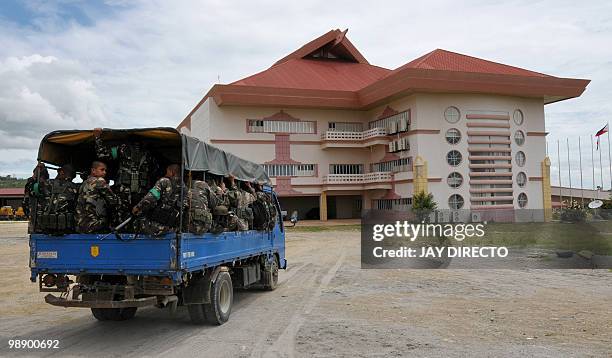 Military soldiers are transported aboard a truck as they patrol in the town of Shariff Aguak in Maguindnao province in the southern Philippines on...