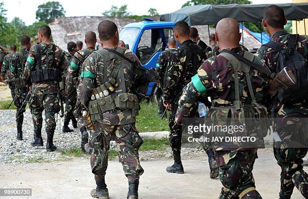 Military soldiers patrol the town of Shariff Aguak in Maguindnao province in the southern Philippines on May 7, 2010 three days before national...