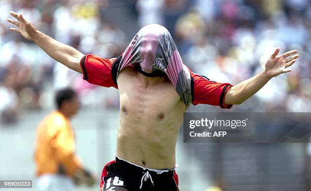 Soccer player Sandro Alfaro celebrates a goal in Guatemala City 14 April 2002. El jugador del Alajuela de Costa Rica, Sandro Alfaro, celebra el...
